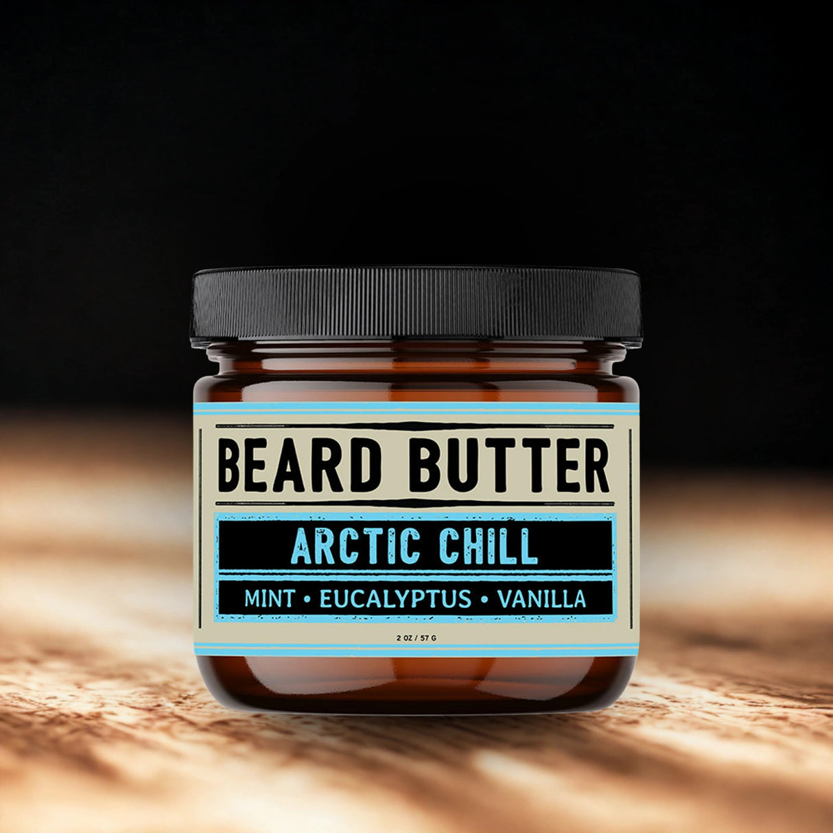 Jar of beard butter labeled 'Arctic Chill' with a black lid on a wooden surface.