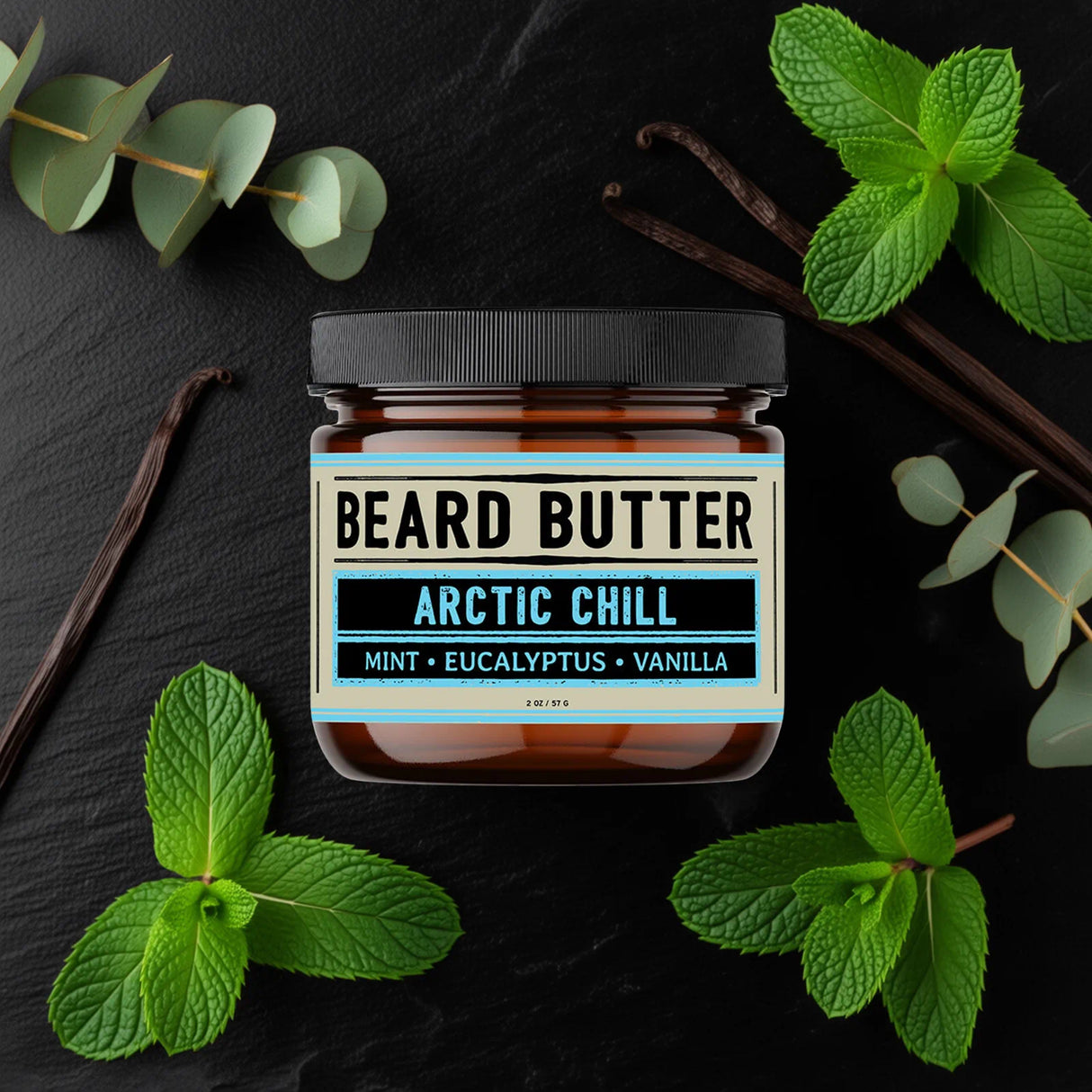 Jar of beard butter labeled 'Arctic Chill' surrounded by mint leaves on a dark background