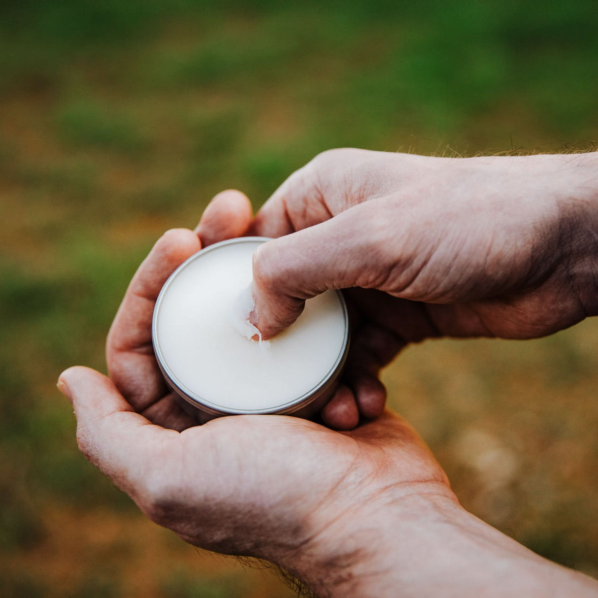 A dollop of Weatherbeard Supply Co Beard Balm being scraped from metal tin, showing the product texture