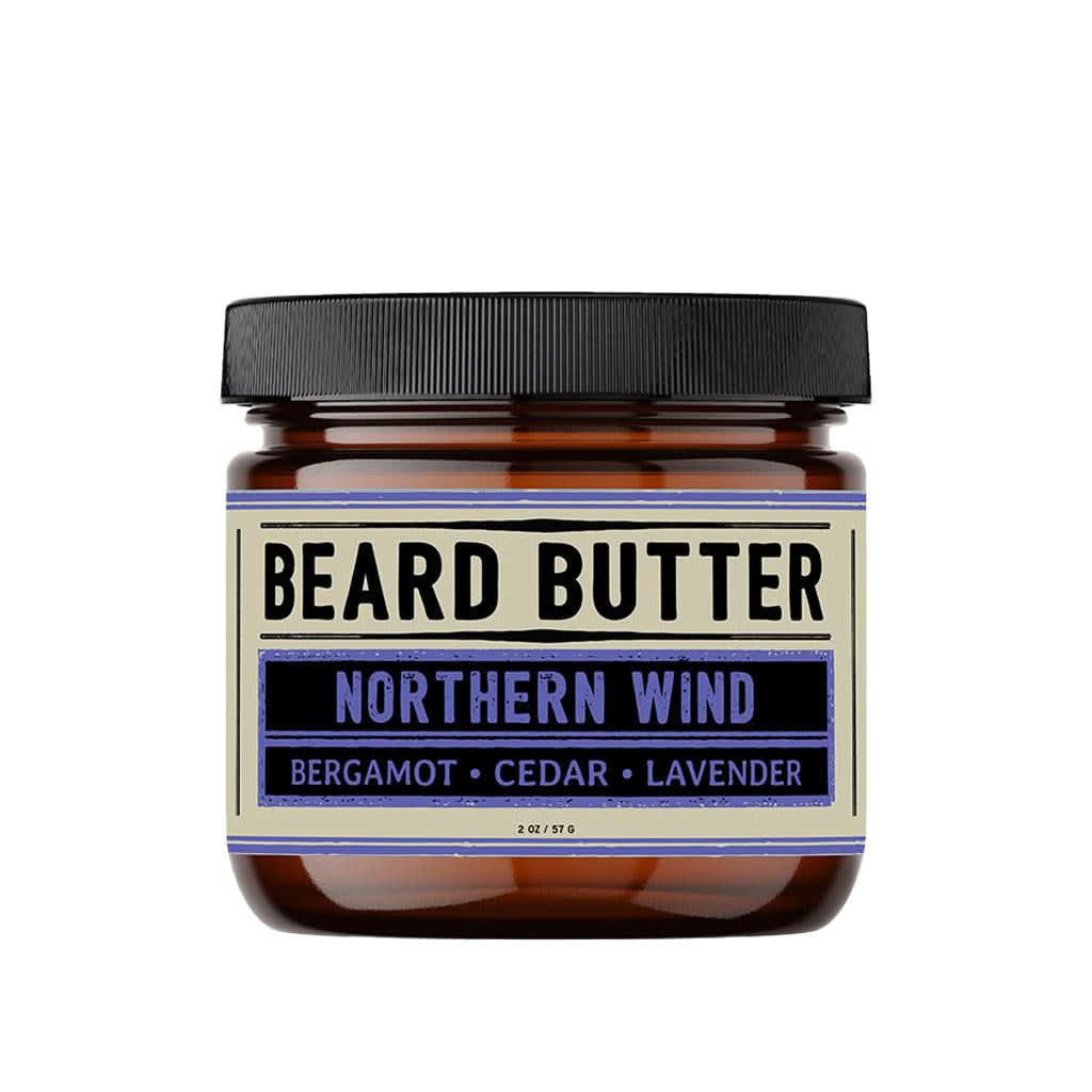 Jar of beard butter labeled 'Northern Wind' with a black lid on a white background
