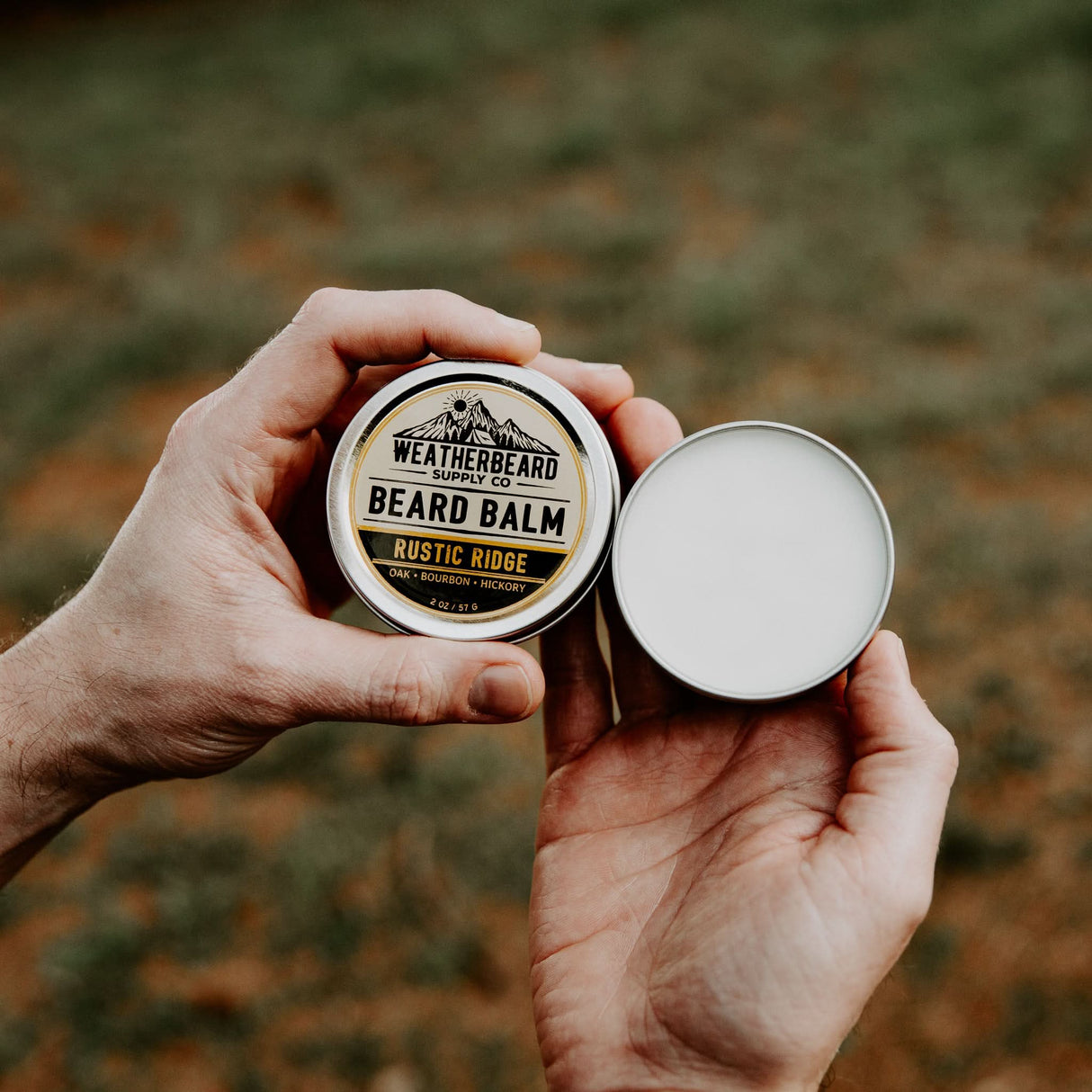 Person holding open container of Rustic Ridge Beard Balm by Weatherbeard Supply Co