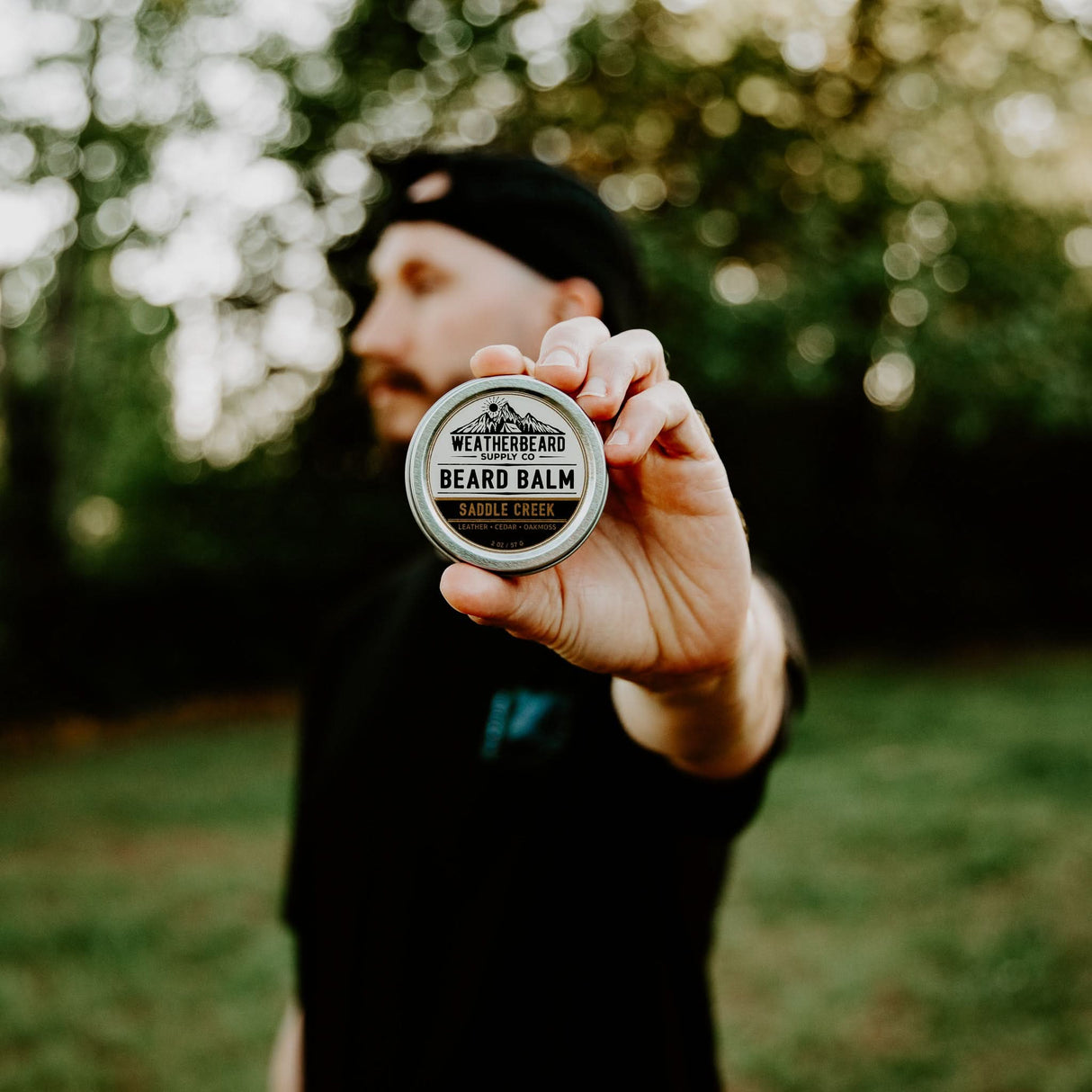 Person holding Weatherbeard Supply Co's Saddle Creek Beard Balm