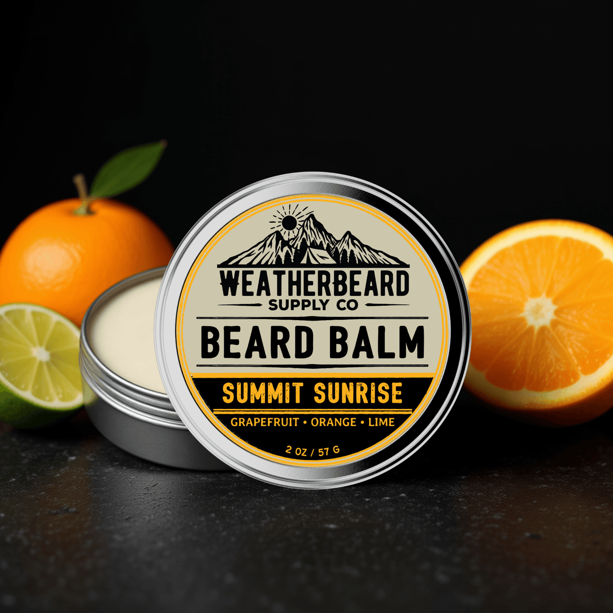 Weatherbeard Supply Co. Summit Sunrise Beard Balm container with oranges and a lime on a dark background