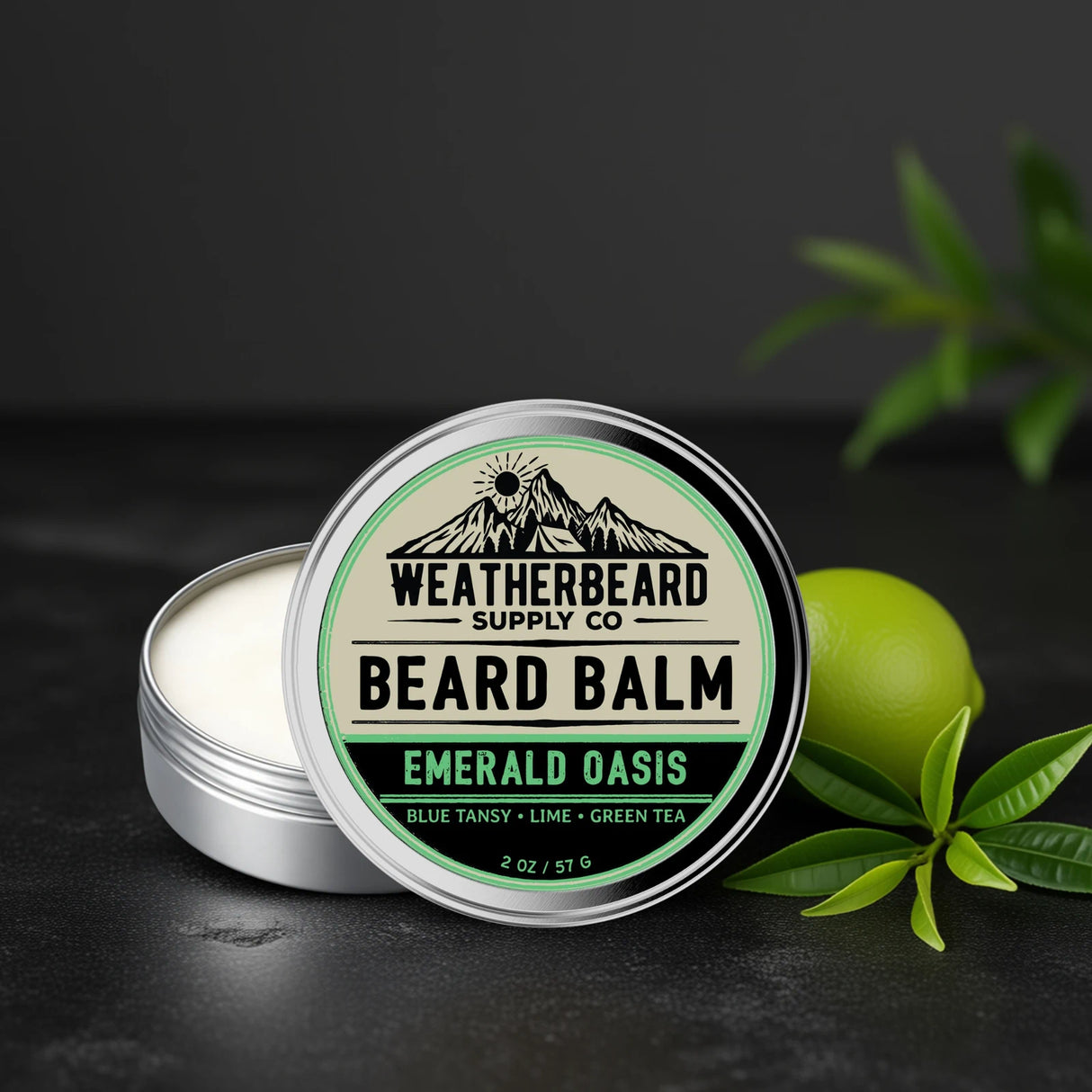 Weatherbeard Supply Co Emerald Oasis Beard balm container on a dark background with a lime and green tea leaves beside it