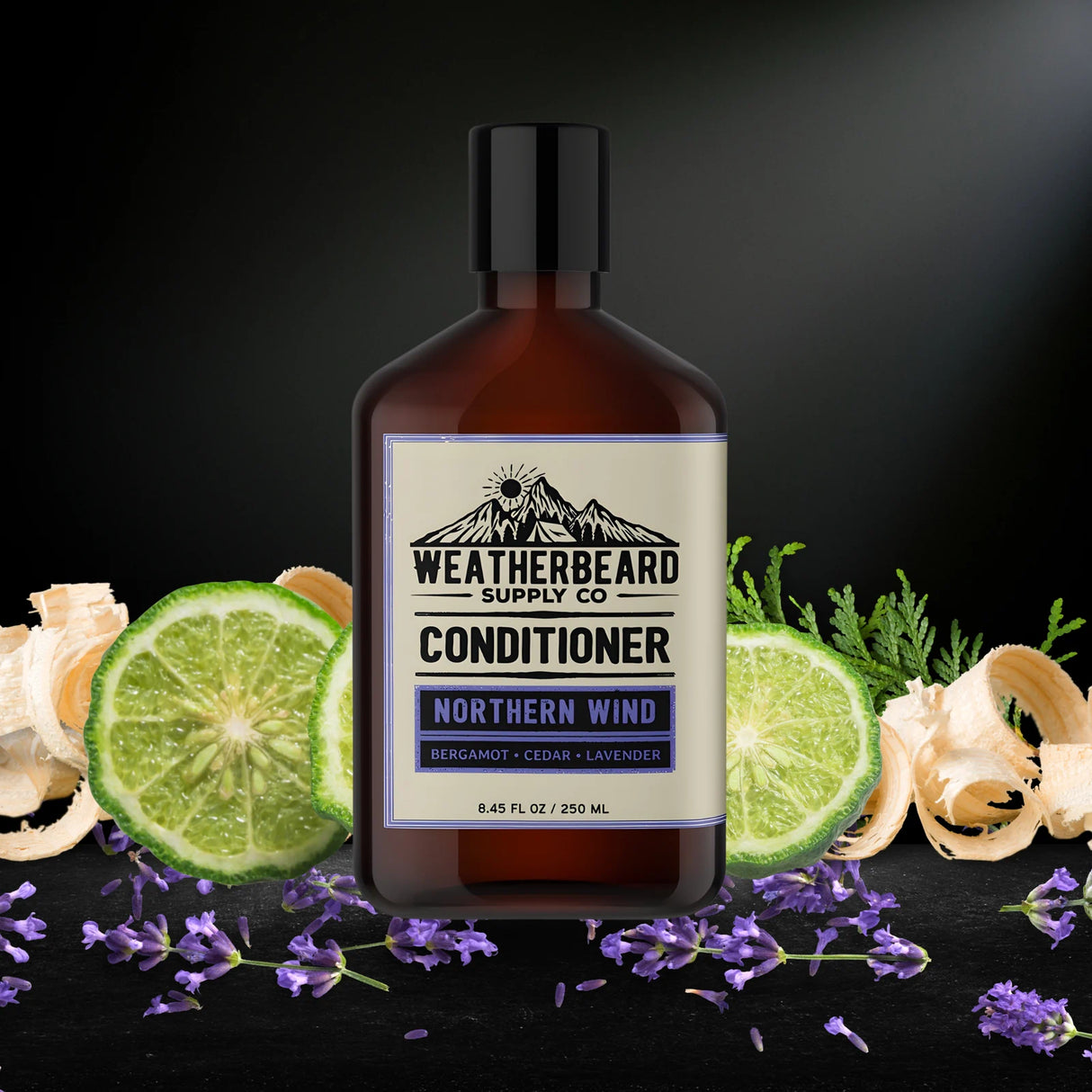 Bottle of Weatherbeard Supply Co. Northern Wind Conditioner with lime slices and herbs on a dark background