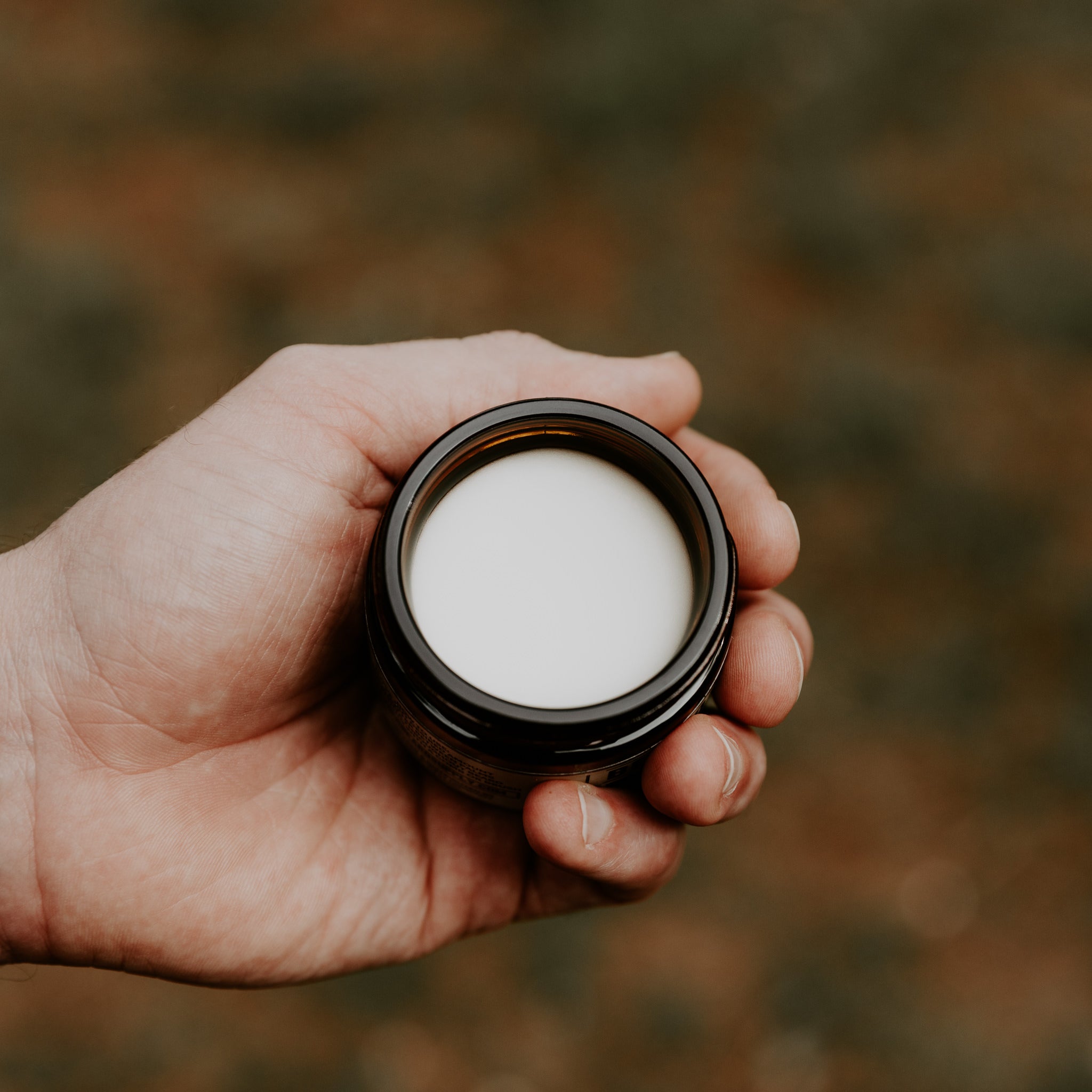 Person holding Weatherbeard Supply Co Beard Butter jar in hand, showing off the texture