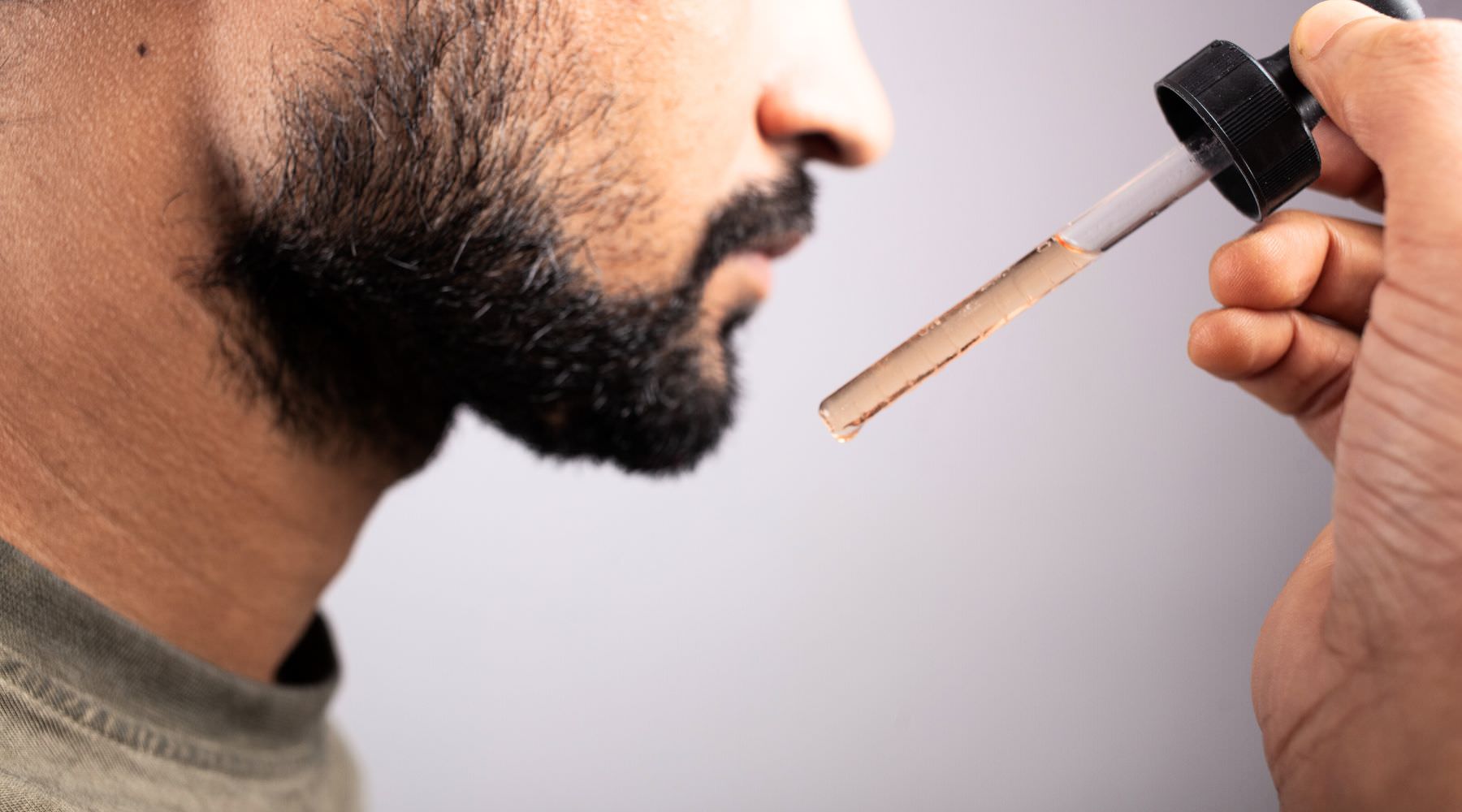 Man applying beard oil for beard growth