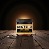 Jar of Amber Trail Beard Butter on a wooden surface with a dark background