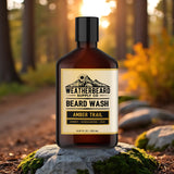 Bottle of Weatherbeard Supply Co. Beard Wash Amber Trail on a rock with a forest background