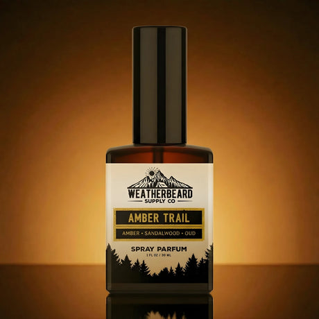 Bottle of Weatherbeard Supply Co Amber Trail spray parfum on a reflective surface with a warm brown background.