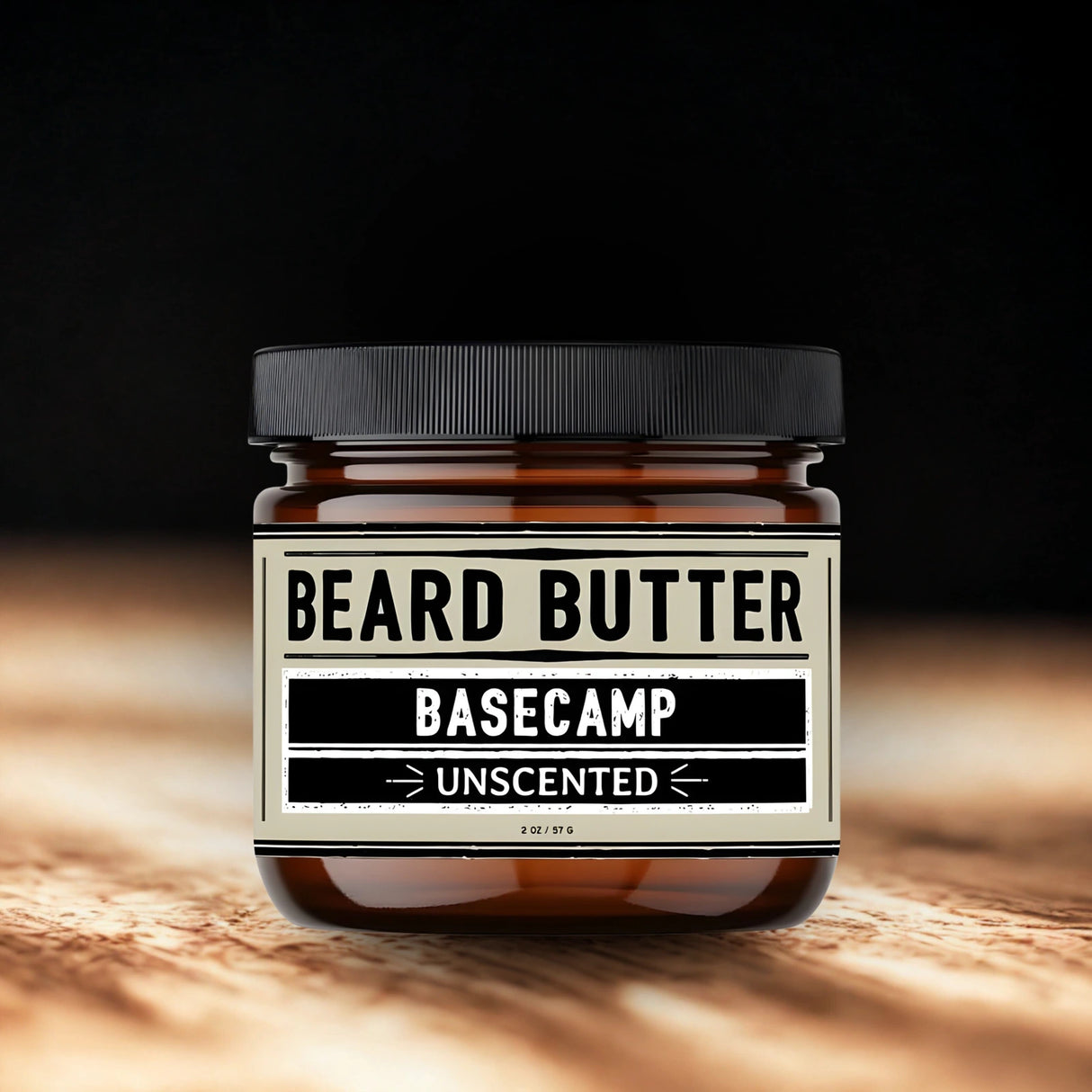 Jar of beard butter labeled 'Basecamp Unscented' on a wooden surface with a dark background