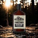 Bottle of Weatherbeard Supply Co. unscented beard conditioner against a forest background.