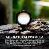 Weatherbeard Supply Co's Beard Butter jar sitting on a tree branch with ingredients listed