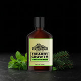 Bottle of Weatherbeard Supply Co. beard growth stimulator wash with peppermint leaves and spruce branches on a dark background