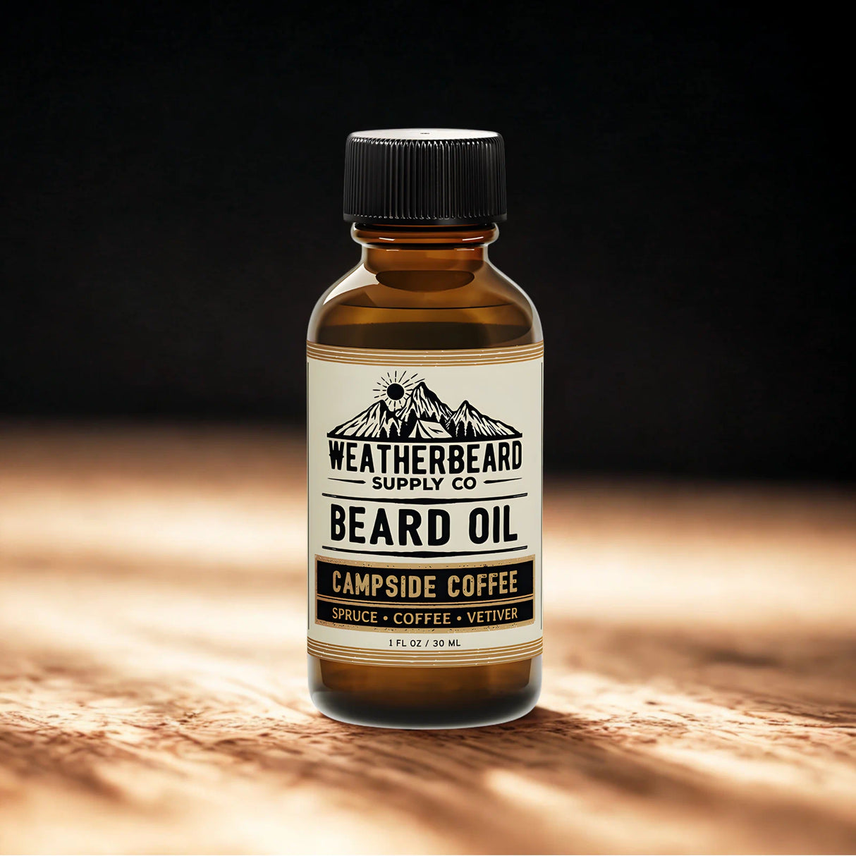 Bottle of Weatherbeard Supply Co. Campside Coffee beard oil on a wooden surface with a dark background