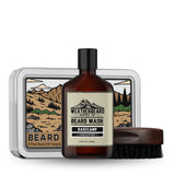 Beard care starter set with beard wash, boars hair brush, and beard oil sample kit featuring mountain design.