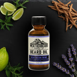 Bottle of Northern Wind Beard Oil on dark background surrounded by bergamot, cedar, and lavender
