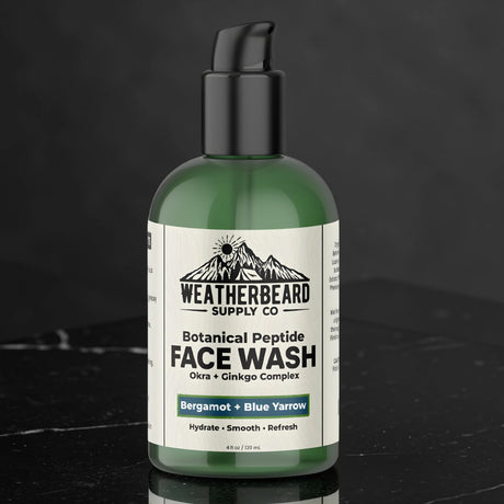 Green bottle of Weatherbeard Supply Co Botanical Peptide Face Wash on a black marble table