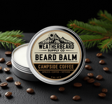 Weatherbeard Supply Co Campside Coffee Beard Balm container on a dark surface with coffee beans and spruce branches.