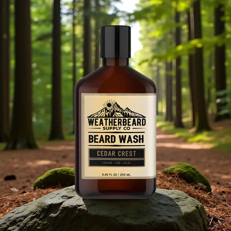 A bottle of Weatherbeard Supply Co's Cedar Crest Beard Wash sitting on a rock out in the forest.