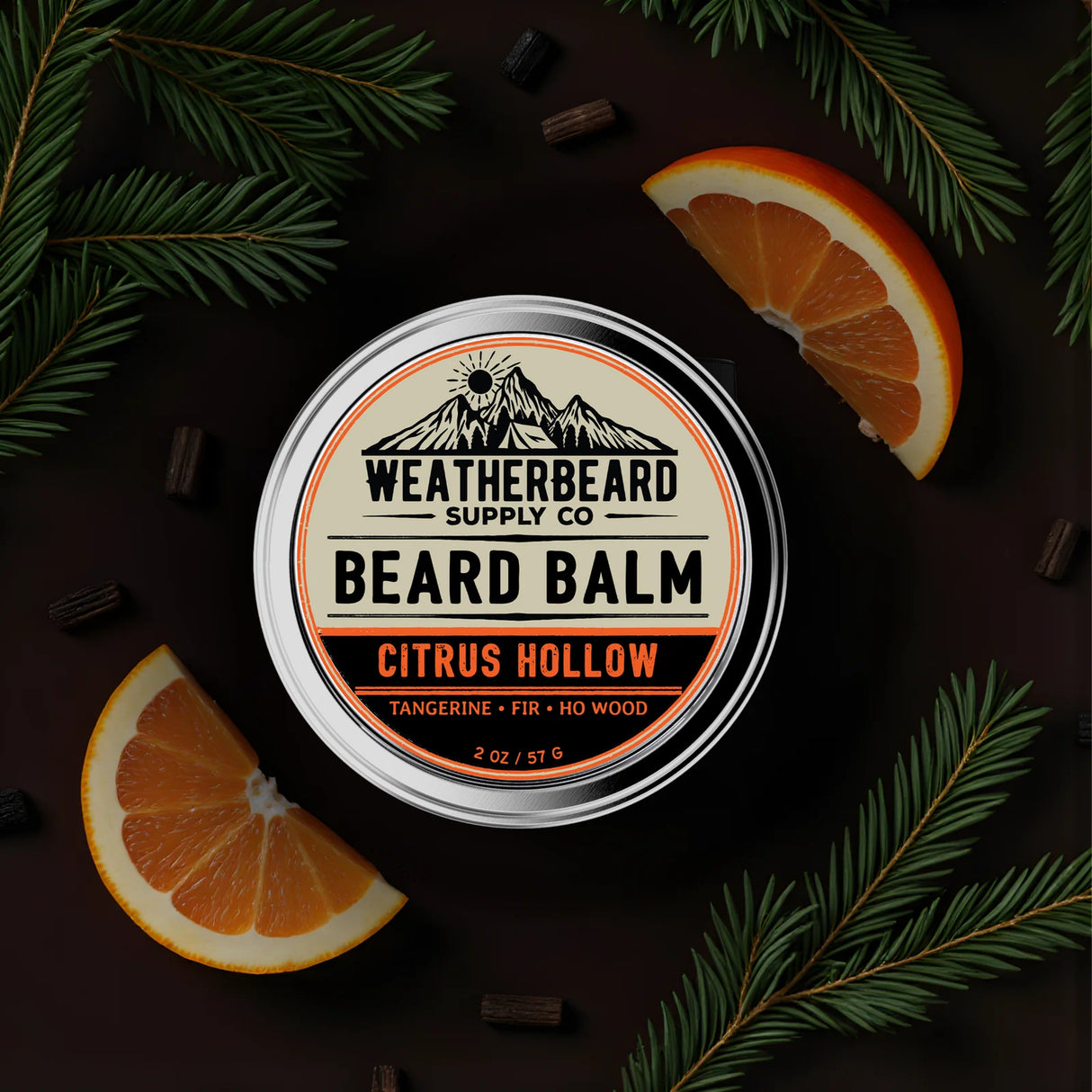 Beard balm container with 'Weatherbeard Supply Co' branding, surrounded by tangerine slices and green leaves on a dark background.