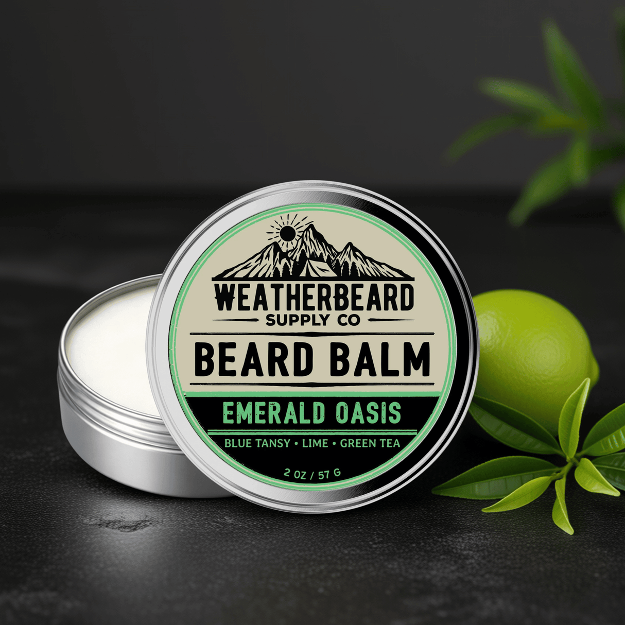 Tin of Weatherbeard Supply Co's Emerald Oasis Beard Balm with lime and green tea leaves surrounding it