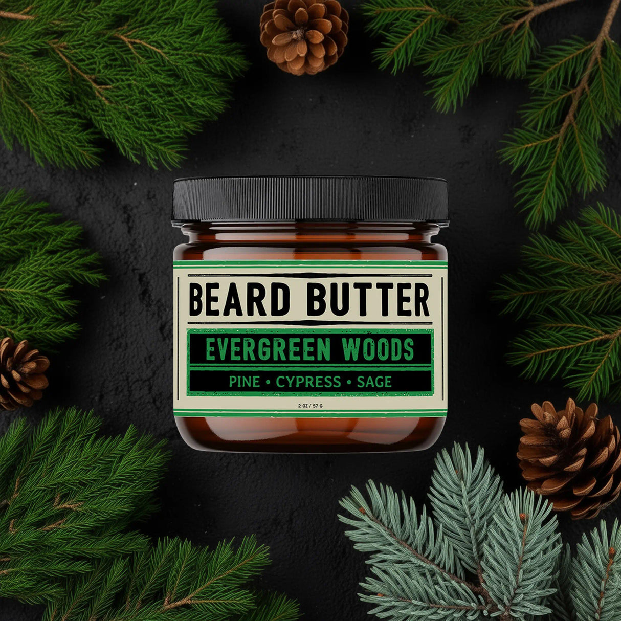Jar of beard butter labeled 'Evergreen Woods' surrounded by pine branches and pine cones on a dark background