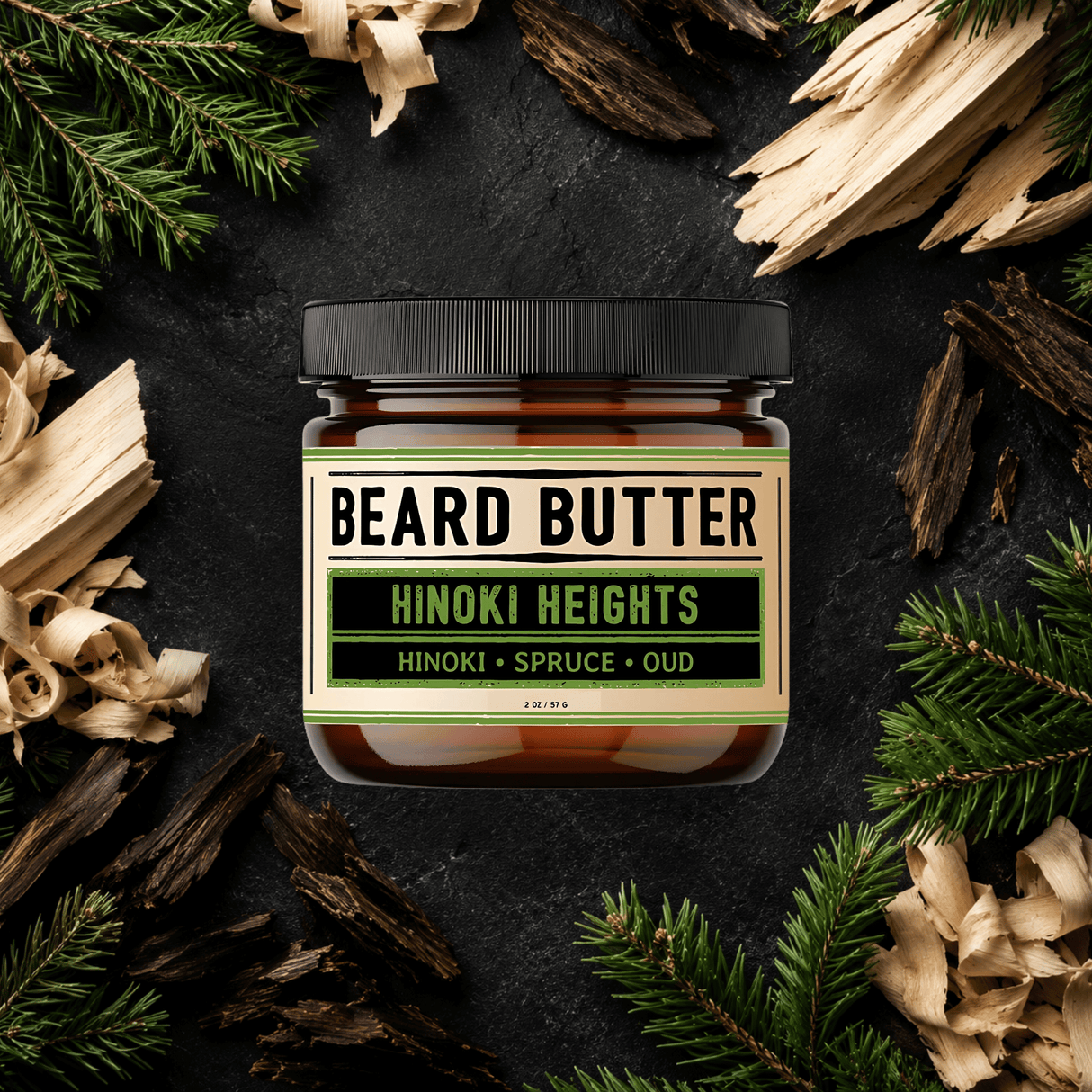 Jar of Beard Butter Hinoki Heights surrounded by hinoki wood chips and spruce branches on a dark background