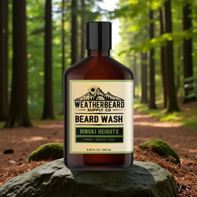 Bottle of Weatherbeard Supply Co. Hinoki Heights beard wash in a forest setting