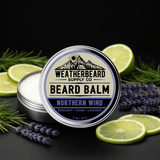 Beard balm container with 'Weatherbeard Supply Co' branding, surrounded by lime slices and lavender on a dark background.