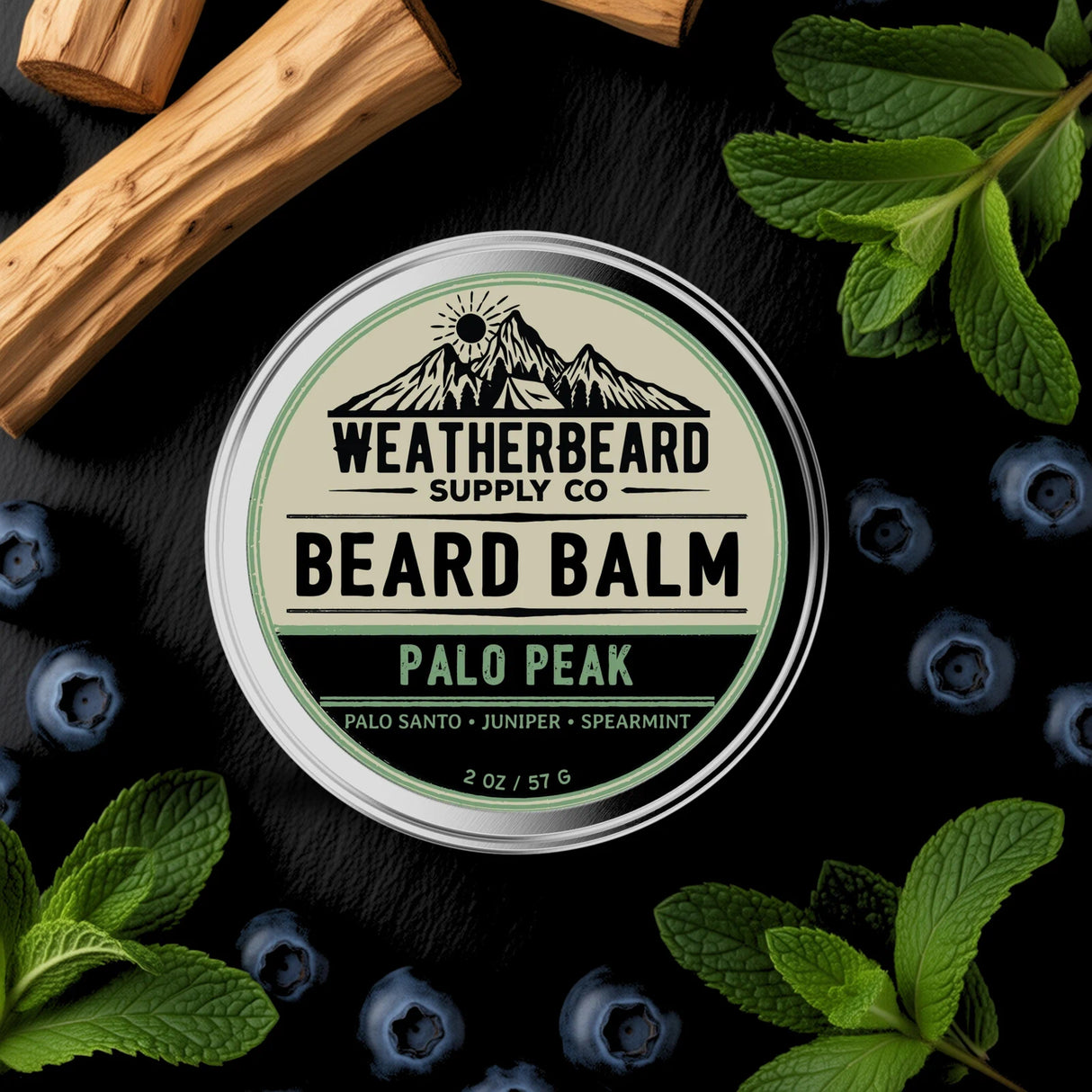 Palo Peak Beard Balm Tin Surrounded By Spearmint Leaves, Palo Santo, and Juniper Berries