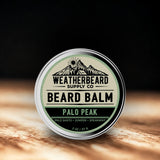 Beard balm container with 'Weatherbeard Supply Co' branding on a wooden surface.