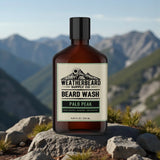 Bottle of Weatherbeard Supply Co Beard Wash with mountainous landscape in the background