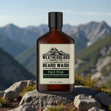 Bottle of Weatherbeard Supply Co Beard Wash with mountainous landscape in the background