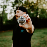 Person holding Weatherbeard Supply Co's Saddle Creek Beard Balm