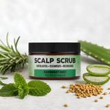 A jar of Scalp Scrub Rosemary Mint exfoliating scalp scrub, styled with fresh rosemary, mint leaves, aloe vera slices, and fenugreek seeds on a light textured background.