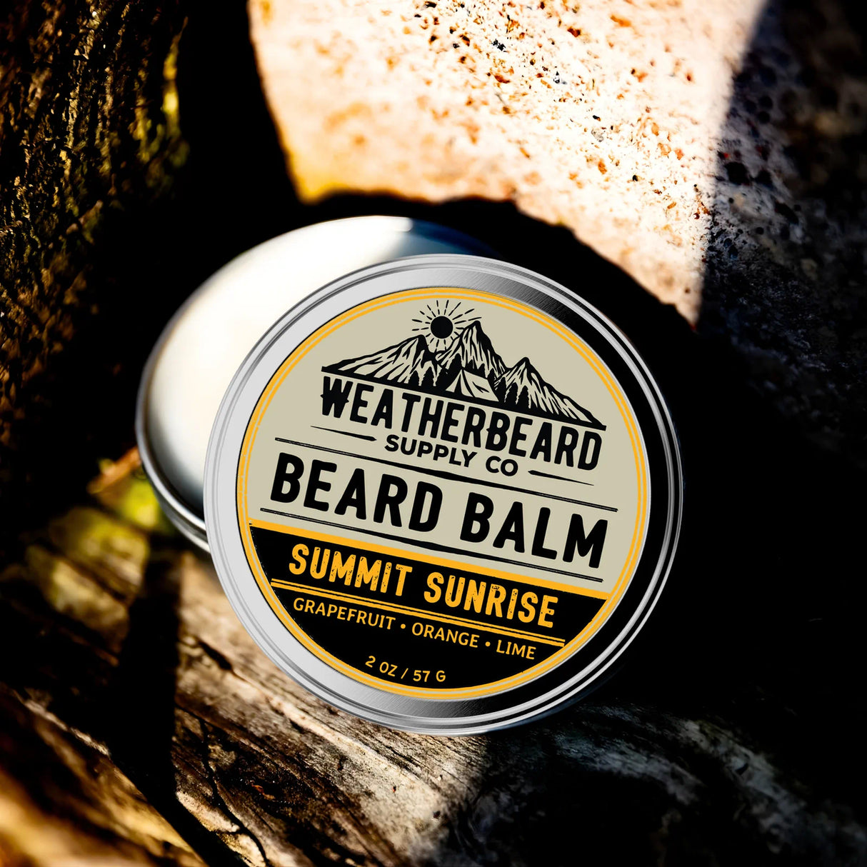Tin of Weatherbeard Supply Co. Beard Balm Summit Sunrise on a wooden background