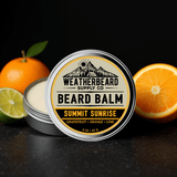 Weatherbeard Supply Co. Summit Sunrise Beard Balm container with oranges and a lime on a dark background