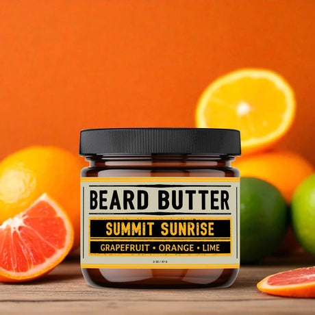 Jar of 'Summit Sunrise' beard butter with citrus fruits on an orange background