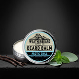 Arctic Chill Beard balm container with 'Weatherbeard Supply Co' branding on a dark background surrounded by vanilla bean and peppermint 