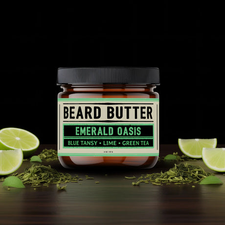 Jar of Weatherbeard Supply Co's Beard Butter sitting on a wooden table with lime slices and green tea leaves surrounding it
