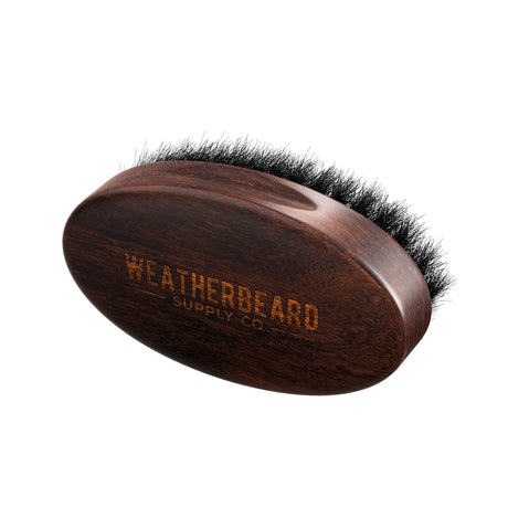 Wooden beard brush with black boar hair bristles on a white background, branded 'Weatherbeard Supply Co'.