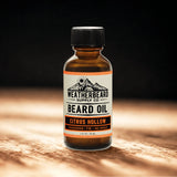 Bottle of Weatherbeard Supply Co. Citrus Hollow Beard Oil on a wooden surface with a dark background