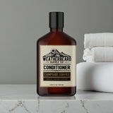 Bottle of Weatherbeard Supply Co. coffee scented beard conditioner on a marble surface.