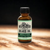 Bottle of Weatherbeard Supply Co. Beard Oil on a wooden surface with a dark background