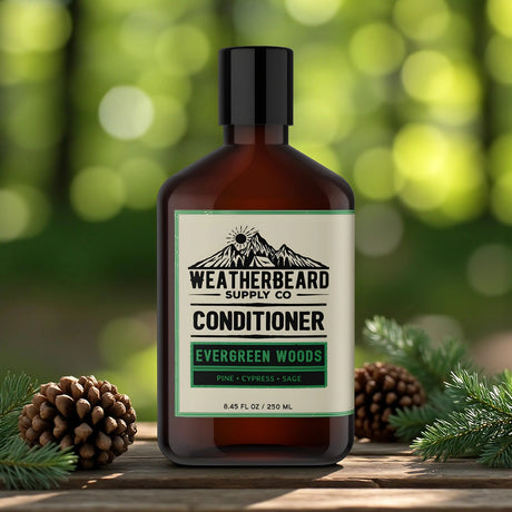 Bottle of Weatherbeard Supply Co Evergreen Woods beard conditioner with pine cones and branches on a wooden surface.