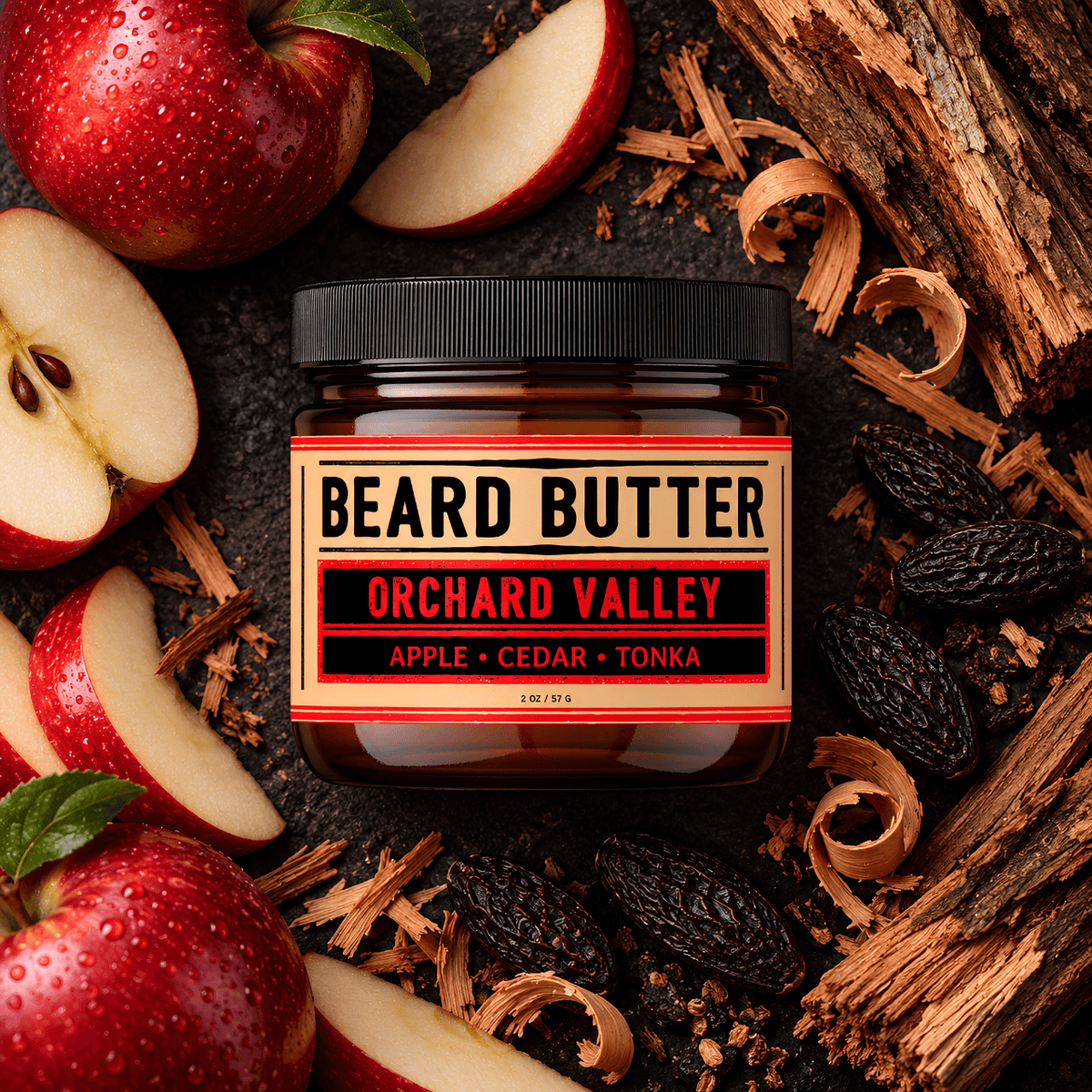 A jar of Weatherbeard Supply Co's Orchard Valley Beard Butter is centered on a dark rustic background, surrounded by sliced red apples, cedar wood shavings, and tonk beans. The jar has a black lid and a cream label with red and black text reading 'BEARD BUTTER', 'ORCHARD VALLEY', and 'APPLE • CEDAR • TONKA'.