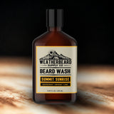 Bottle of Weatherbeard Supply Co. Citrus  Beard Wash with a mountain label on a dark background