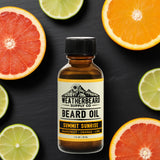 Bottle of Weatherbeard Supply Co. Summit Sunrise beard oil with citrus fruits on a dark background