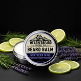 Northern Wind Beard balm container with lavender and bergamot slices on a dark background